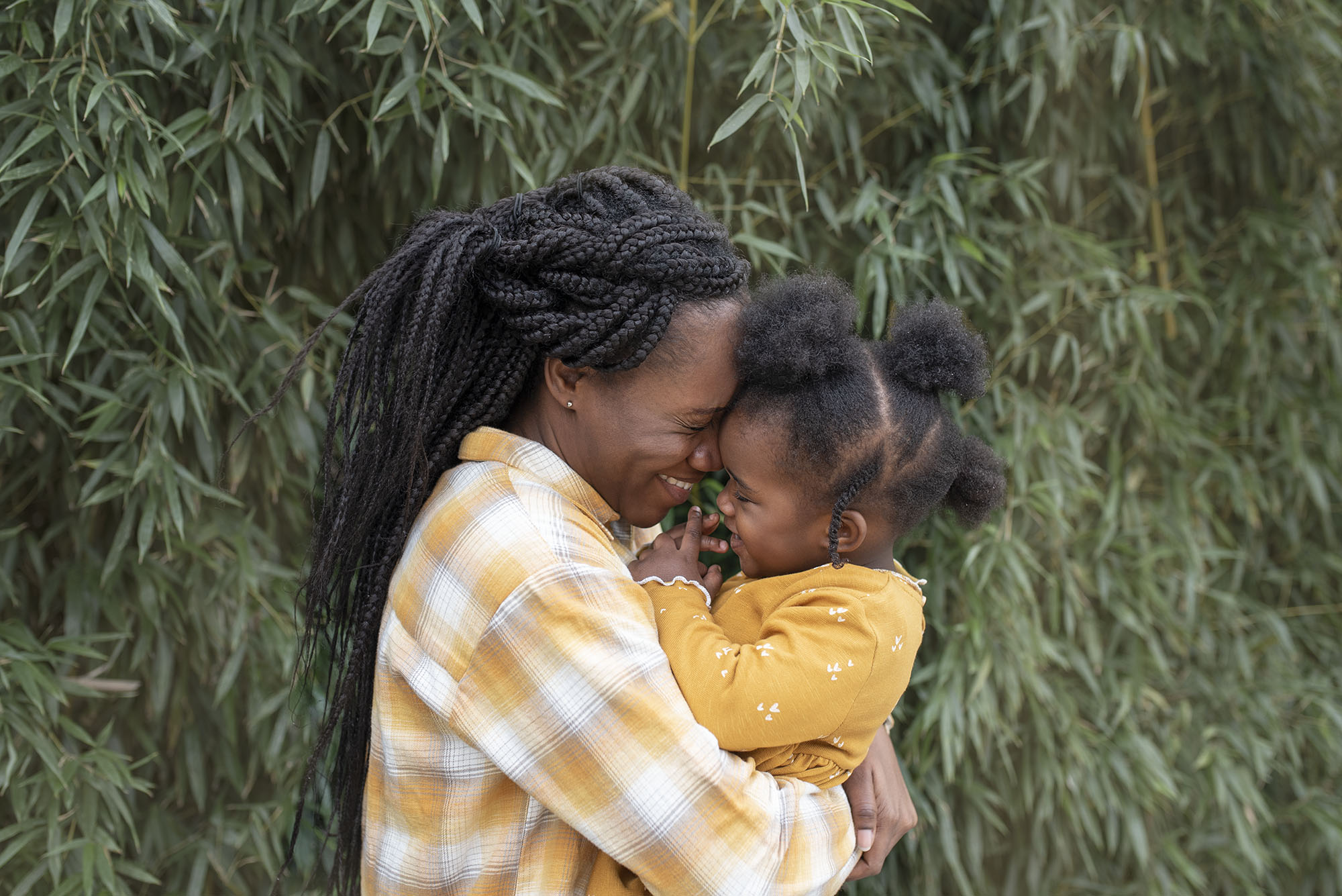 Mother hugging her daughter in a sweet moment during an outdoor family photography session