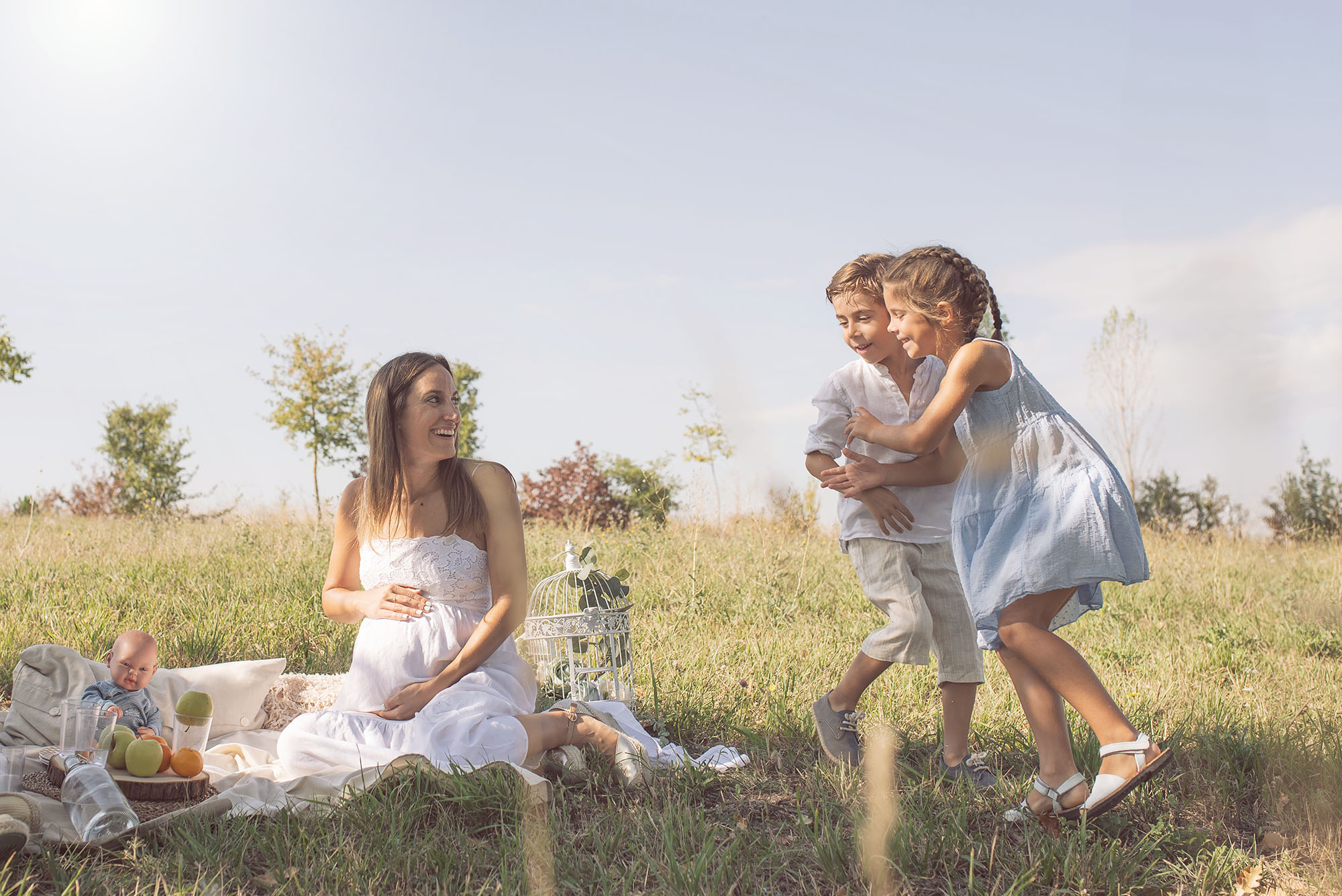 children running around pregnant mother outdoor family session