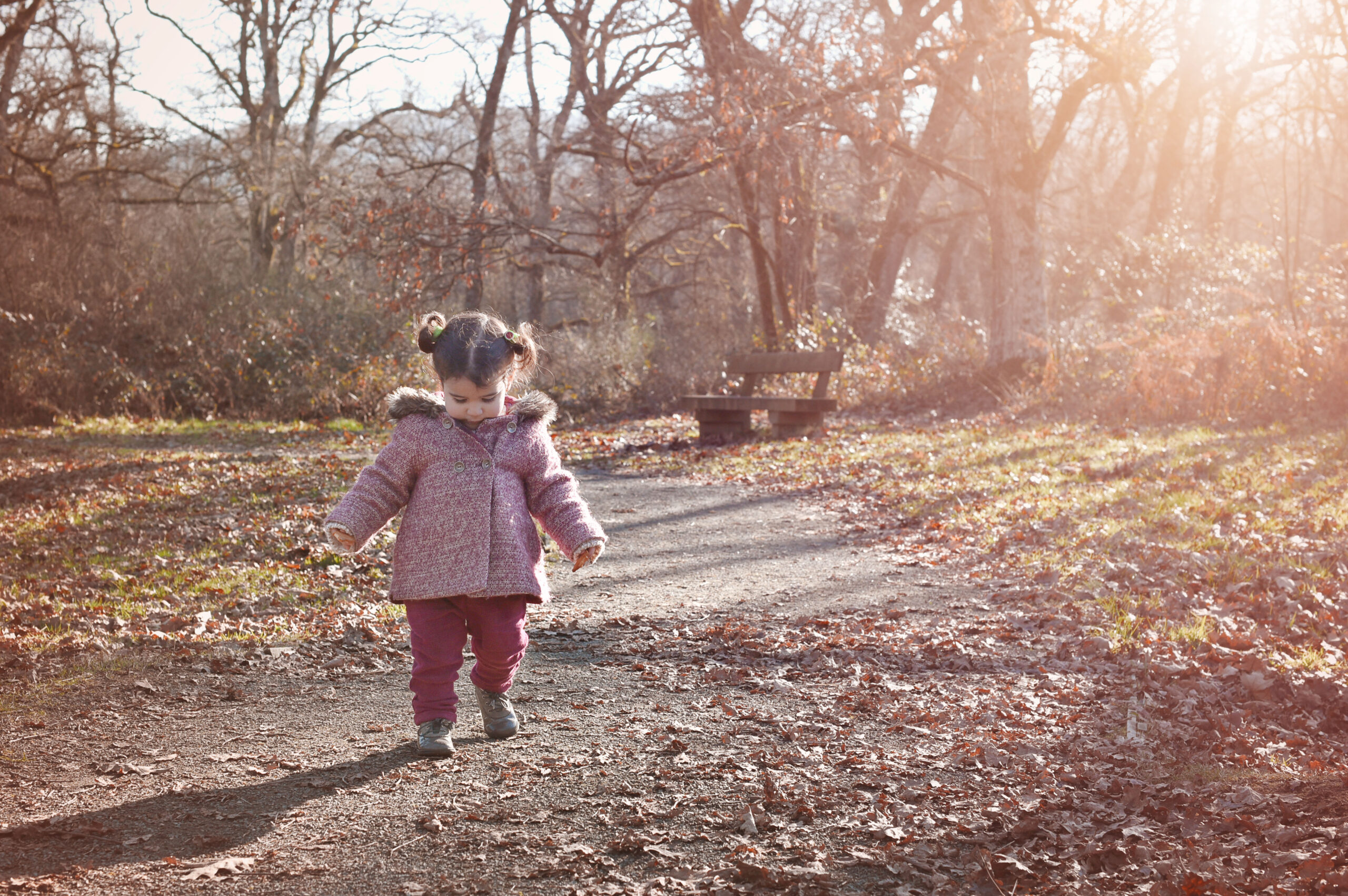 Little girl exploring during a joyful outdoor family session.