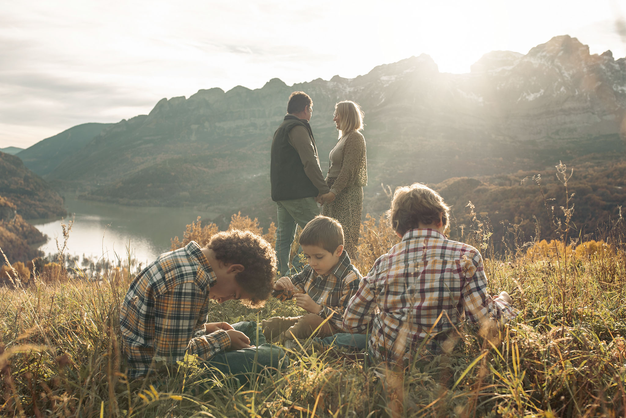 Outdoor family photography session with parents and children walking in the woods.