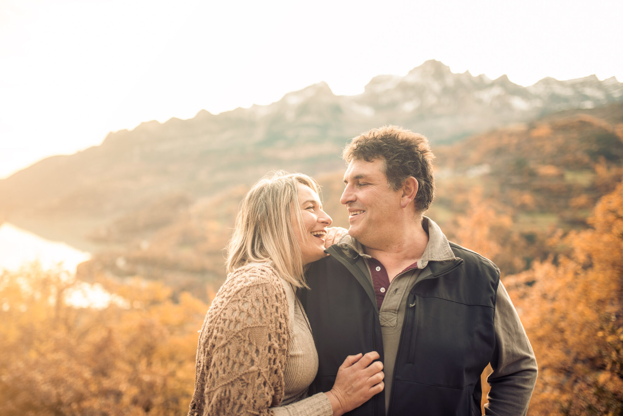Couple connection in autumn landscape with warm sunset light